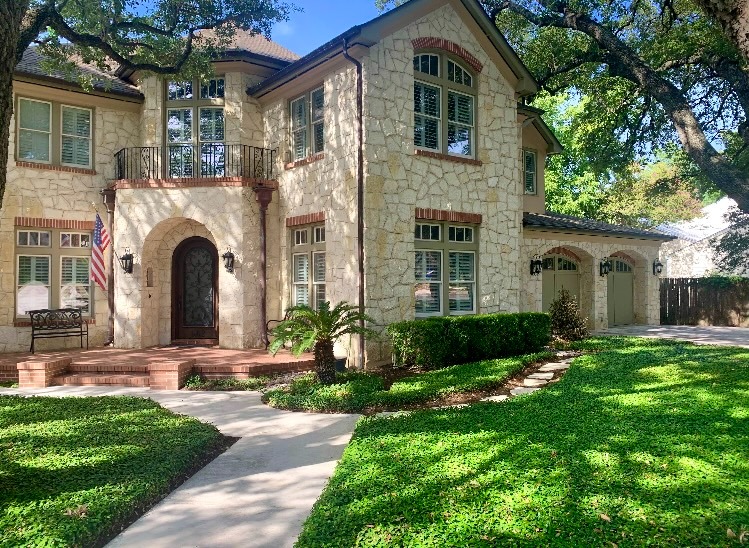 Stone mansion with arched windows under oak trees, Elegant Restorations San Antonio