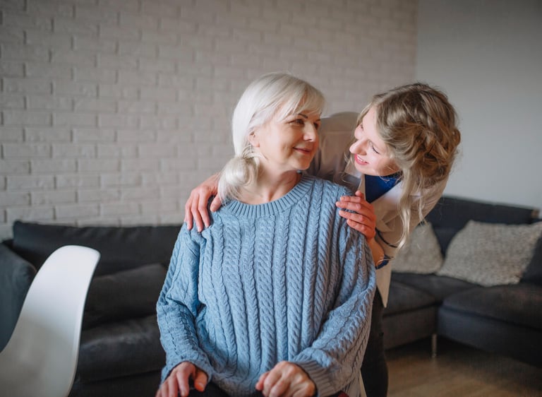 A compassionate home care worker discussing with an elderly woman.
