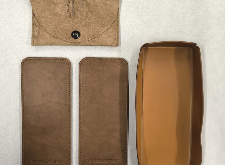 Custom brown leather valet tray with matching pouches and embossed logo branding.