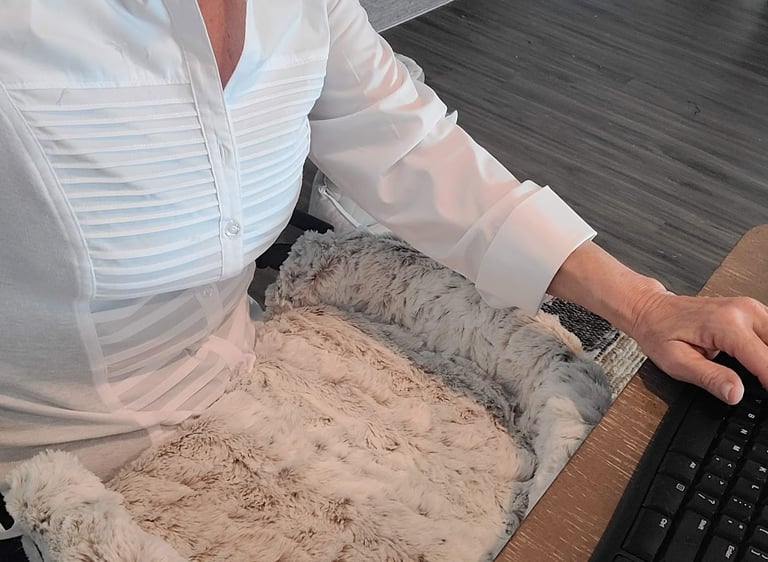 Lady at computer with Furr Lap Pet Bed in her lap 