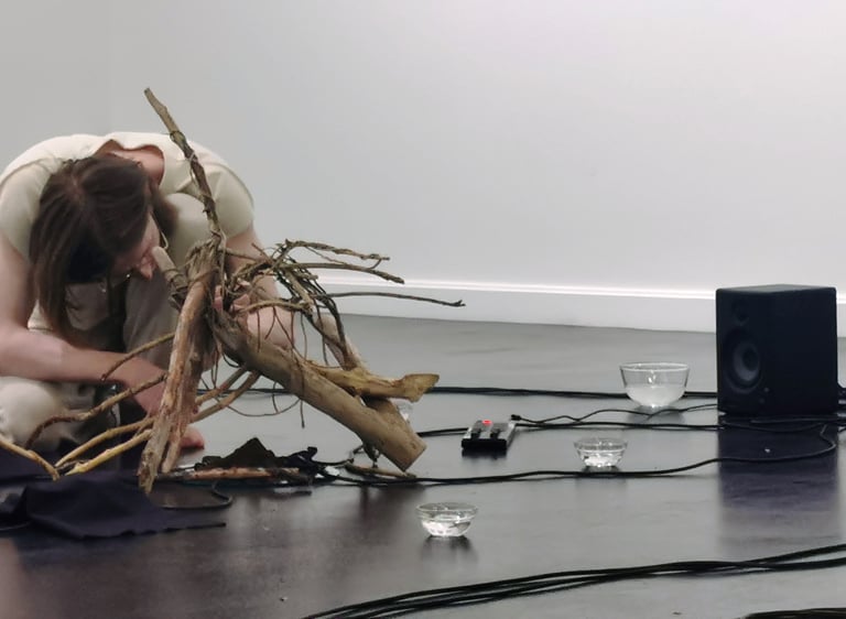 performance artist with wooden sculpture