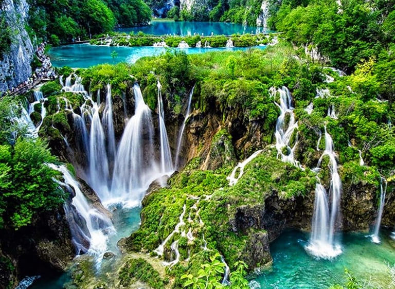 The photo shows amazing nature - a 3 turquoise blue lakes and the amazing waterfalls flowing between them,and greenery around