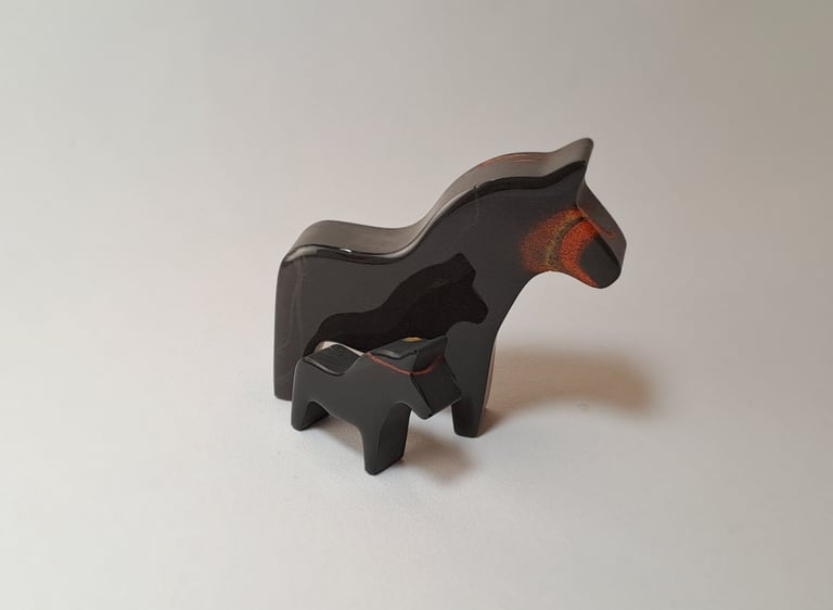 Handcrafted black gypsum horse and foal figurines with rustic painted details.