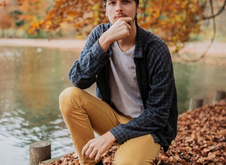 Marc Brunnert sitting on a pile of leaves