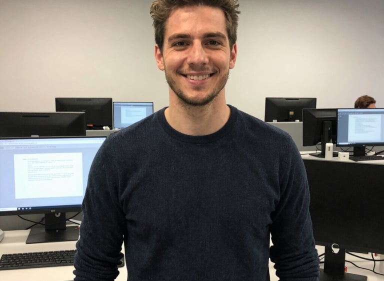 A sleek black and white photo of a technician assisting a client with computer setup.