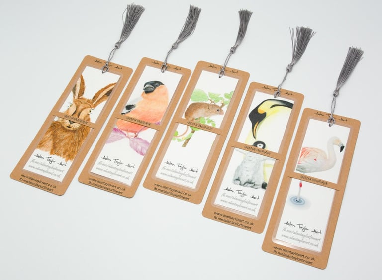 A collection of illustrated animal bookmarks with tassels featuring a hare, bird, mouse, penguin, and flamingo.