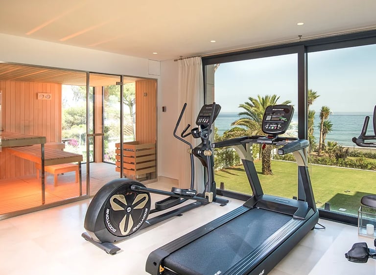 Private gym with sea views and glass front sauna