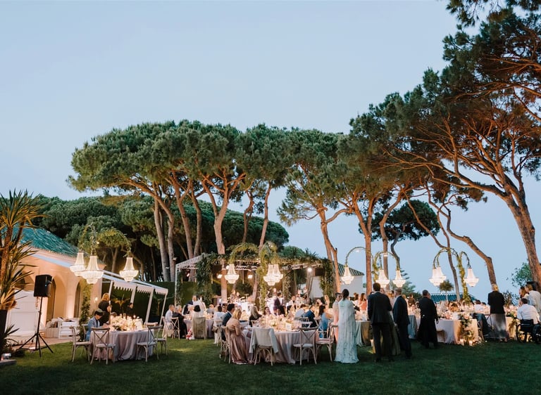 Evening gala dinner under chandeliers by the sea