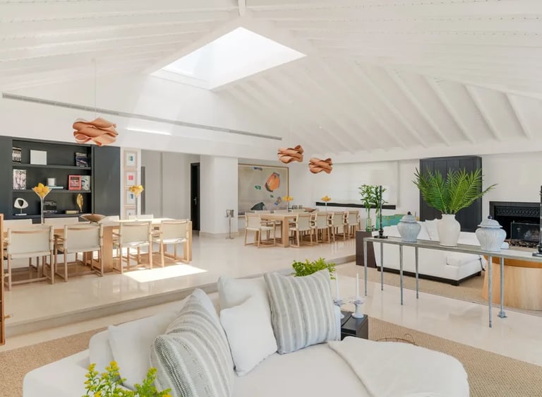 Spacious open-plan dining and lounge area with skylight at Villa El Olivo, Marbella