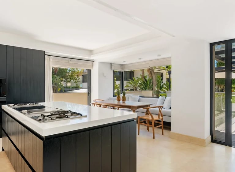 Bright kitchen with garden views and dining area at Villa El Olivo, Marbella