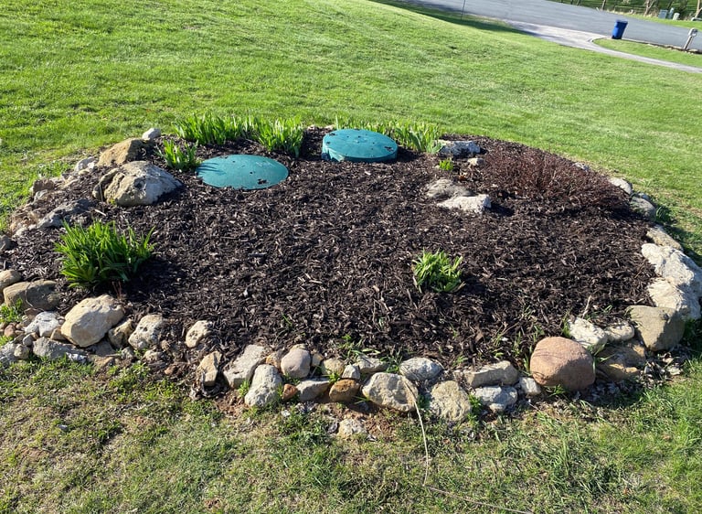 Expert mulch installation and stone edging around septic covers—custom lawn care solutions in Appleton