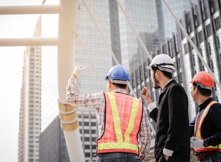 a group of construction workers standing in front of a building