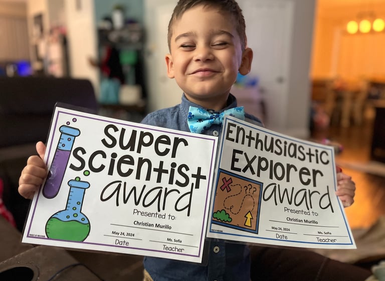 boy holding certificates