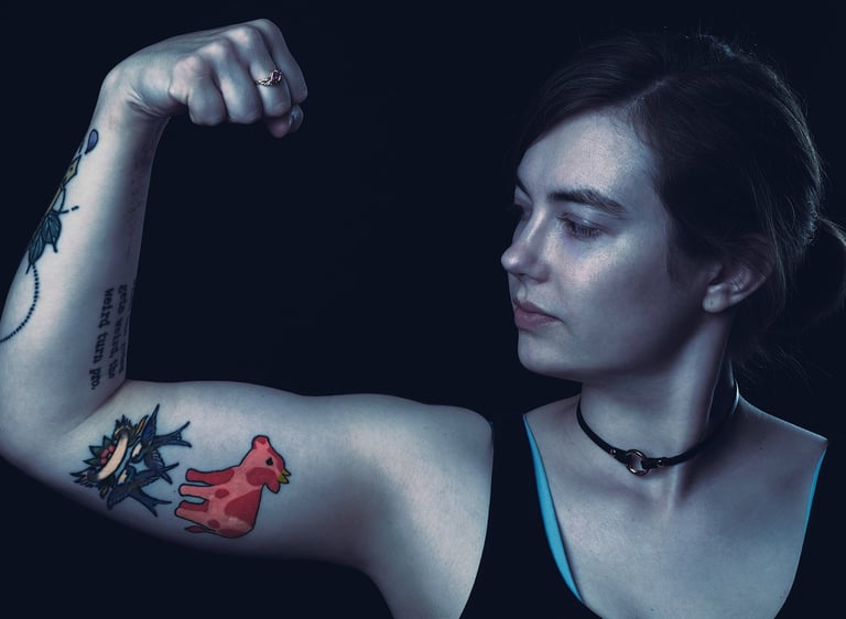 a woman with cow tattoos on her arm in a dark mood environment