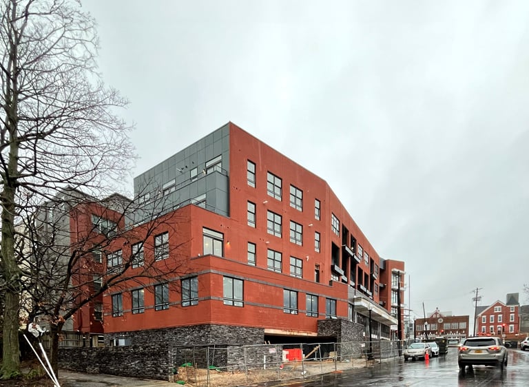 A photograph of a red brick apartment building