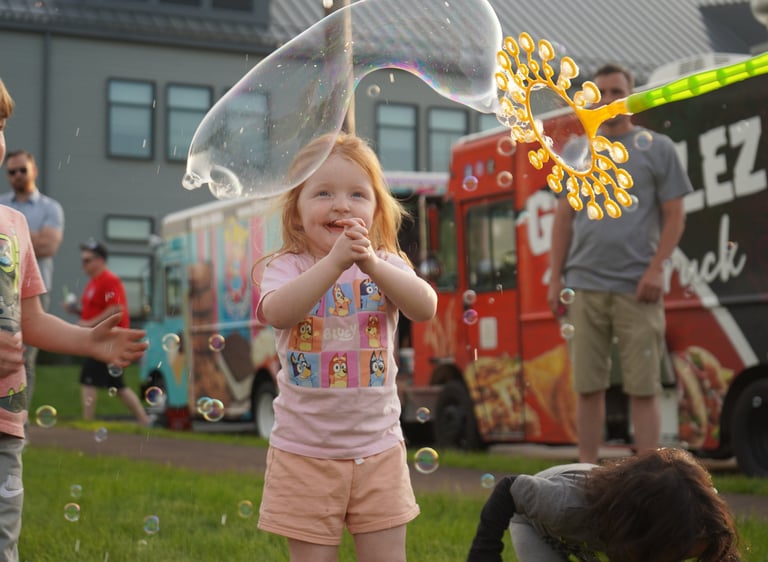 Little girl claps at the bubbles