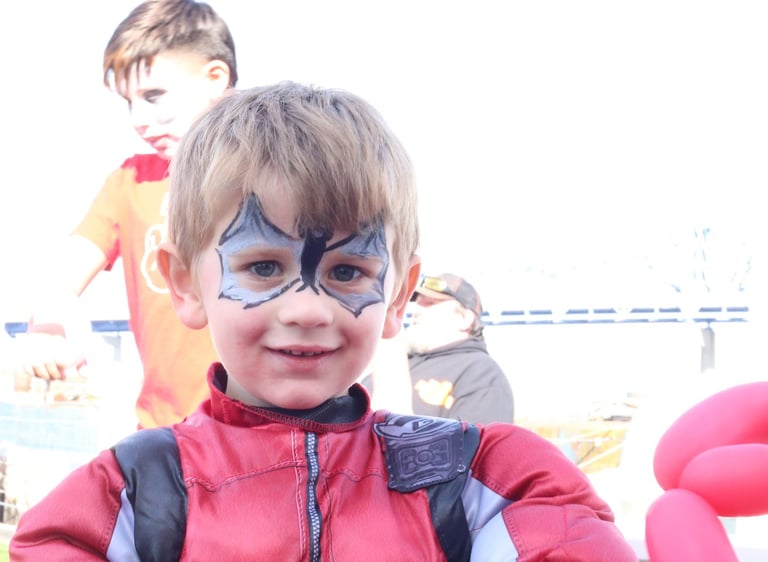 Little boy showing his face paint
