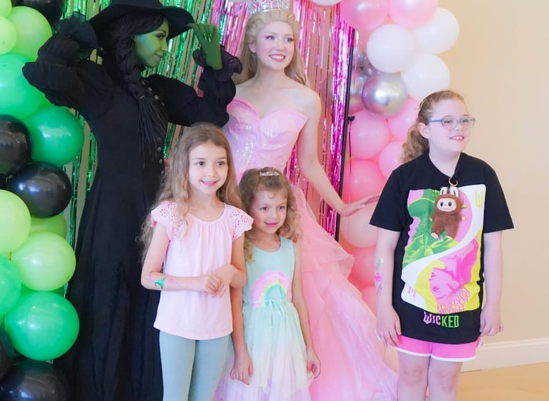 Elphie and Glinda pose for a photo with guests