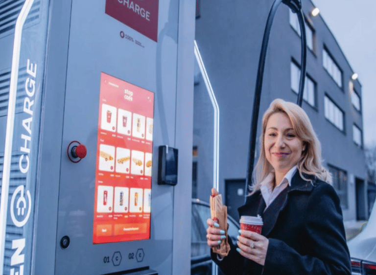 Willbert and BuyBERT a woman in a black jacket is holding a cup of coffee