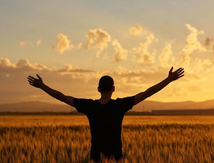 A person mindfully enjoying a sunset