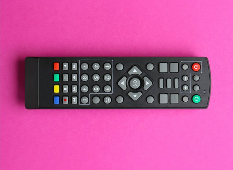 Pink background featuring a television remote control in the center.