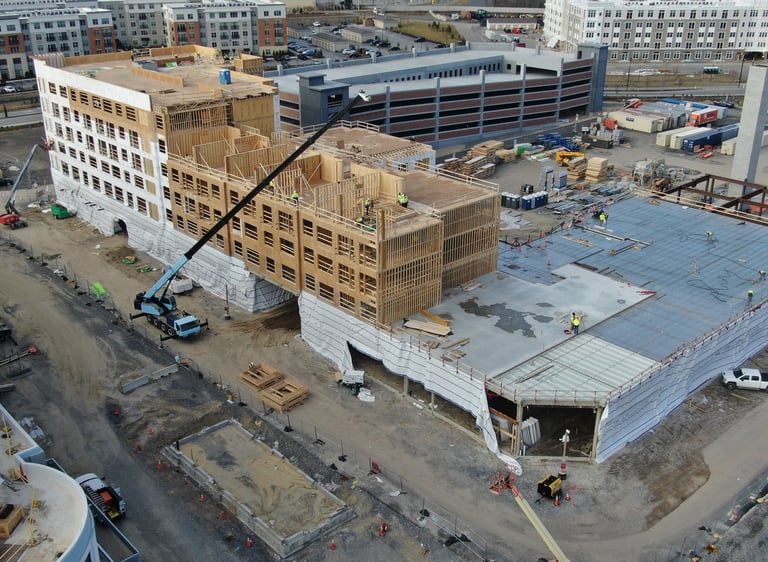 a large Wood Paneling Frame building with a crane in the foreground
