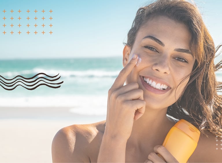 Smiling woman applying facial sunscreen at the beach for summer skin protection.
