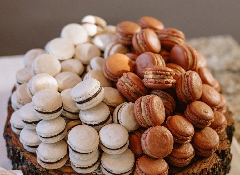 A pile of macarons shown as part of a luxury wedding dessert table