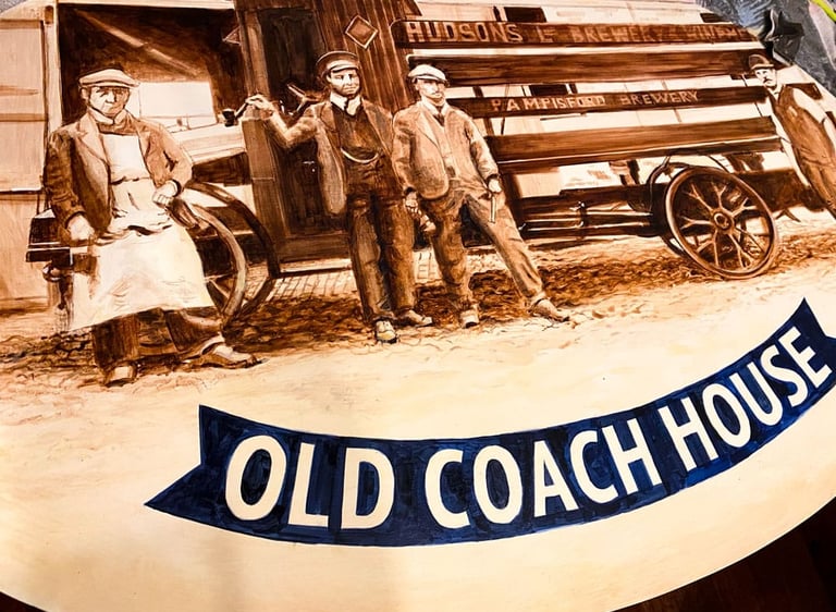 Close-up of angled pub sign with painted brewery staff