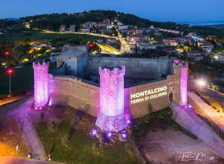 The medieval Montalcino Fortress illuminated in pink for the Giro d'Italia cycling race.