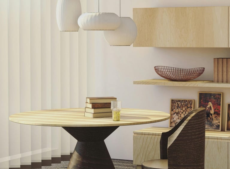 Minimal dining nook with sculptural table and soft neutral interior palette.