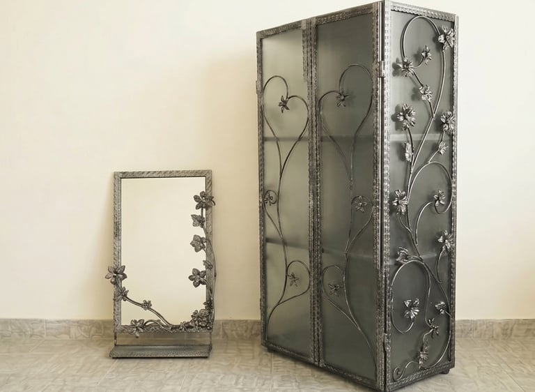 Elegant wrought iron display cabinet and matching mirror featuring intricate floral vine designs.