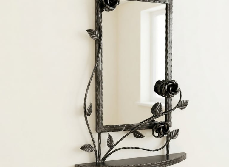 Ornate hand-forged wrought iron wall mirror with black rose vines and a built-in metal shelf.