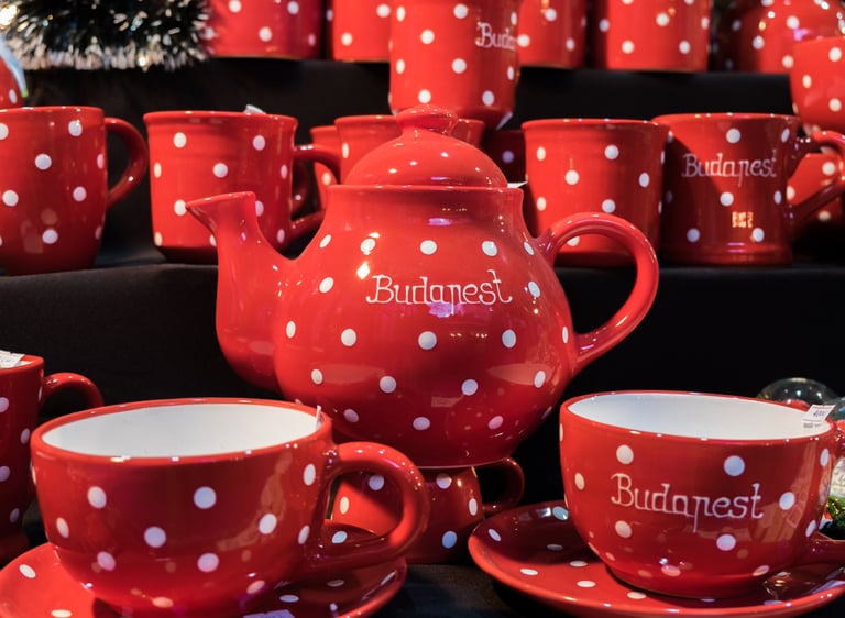 Red and white polka dot ceramic teapot and mugs souvenir set from a Budapest market.