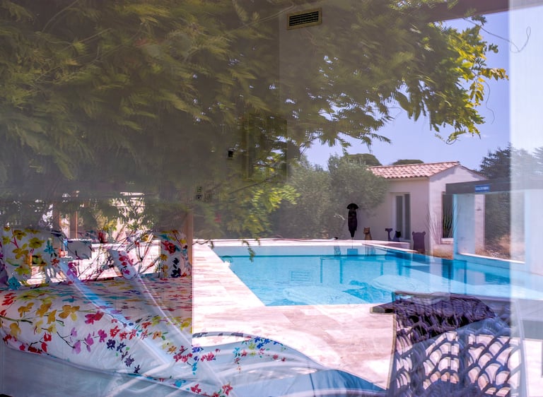 Bedroom with king size bed, swimming pool view being seen from outside at Domaine Des Lucques