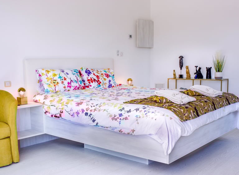 Bedroom with king size bed, air conditioner, built-in bathroom and television at Domaine Des Lucques