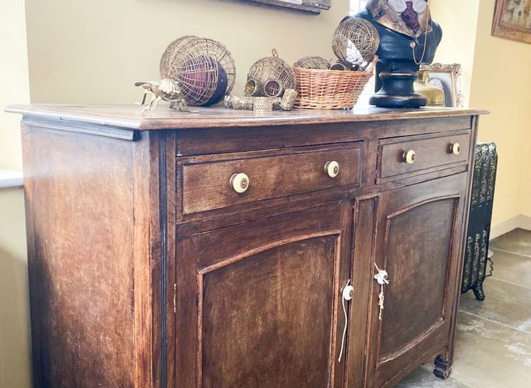 Image of a sideboard that is brown wood and could be painted