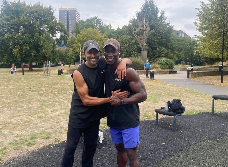 Two athletic men smiling at an outdoor gym park after a fitness workout.