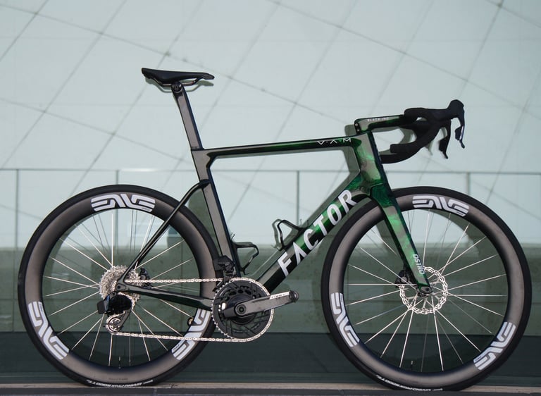 A Factor OSTRO VAM aero road bike with green camouflage paint and ENVE carbon wheels.