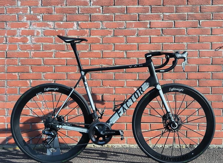 a custom Factor O2 parked on the side of a brick wall