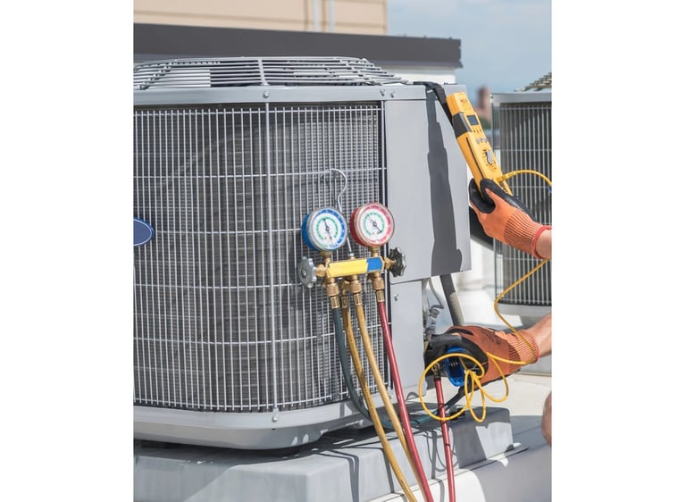 An HVAC technician uses pressure gauges and a multimeter to perform maintenance on an AC unit.