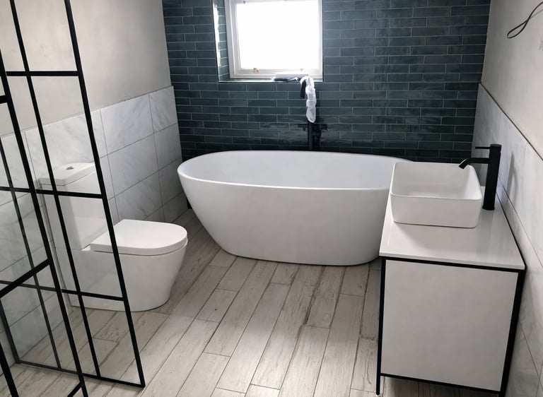 Contemporary bathroom with freestanding bath and dark feature tiles in Brighton home renovation.