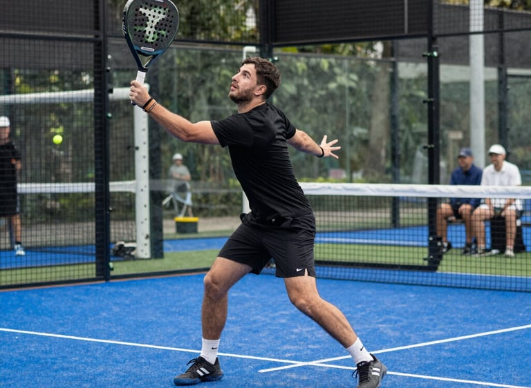A lively padel tournament with players celebrating and spectators enjoying the match