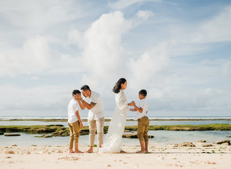Family beach photography at Melasti Beach Bali, relaxed cinematic family session