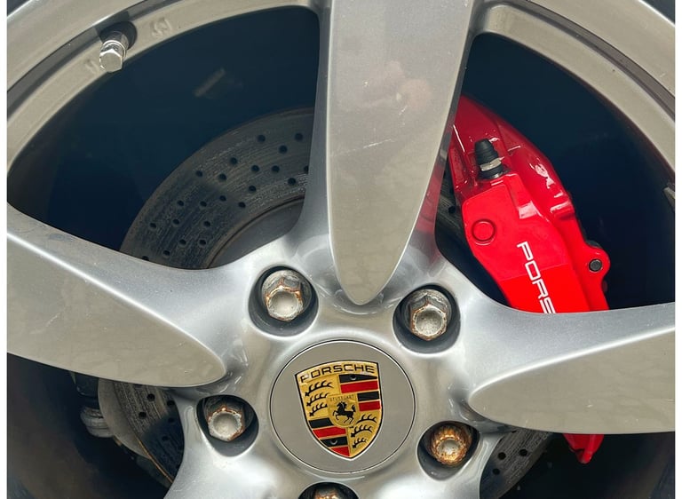 highly polished Porsche wheel with red calliper