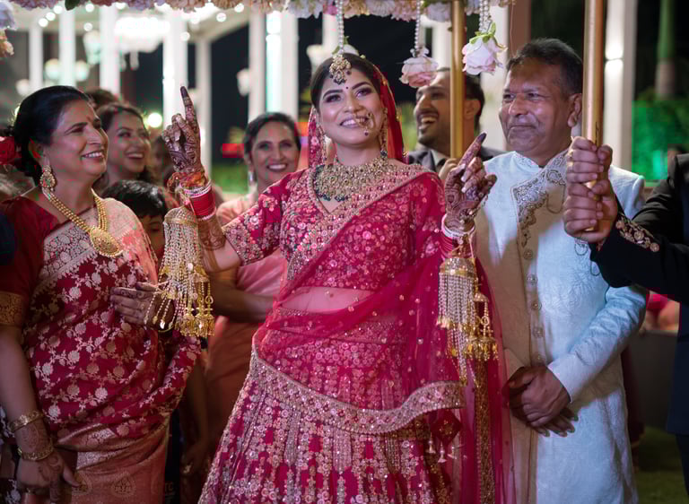 Bride in red lehenga at her wedding.
