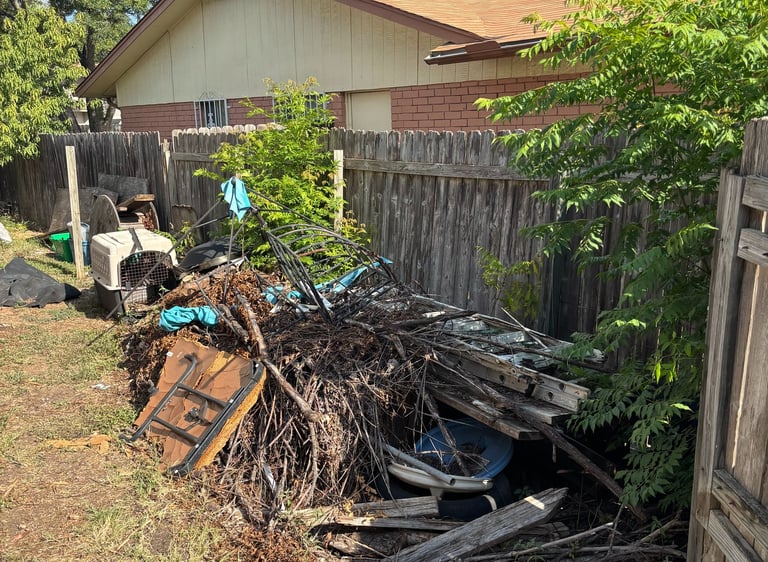 backyard in fair oaks ranch full of branches and backyard debris