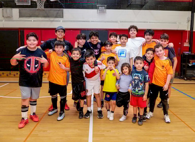 A diverse youth indoor soccer students MVB FC posing for a group photo in Mississauga