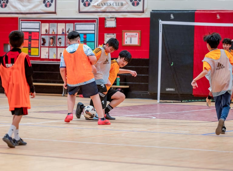 Young MVB FC students playing indoor soccer game in Mississauga