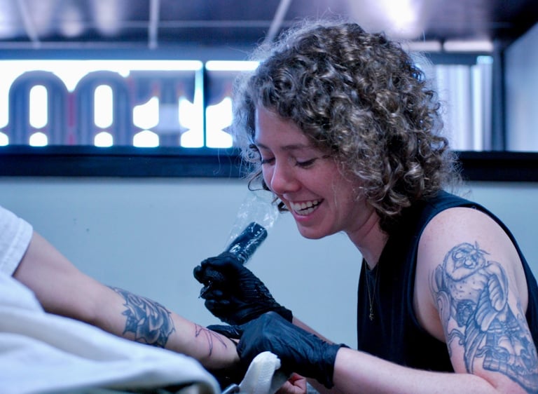 a woman tattoo artist tattooing